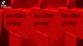 a cartoon character with a big smile on his face is standing in front of a row of red blocks .