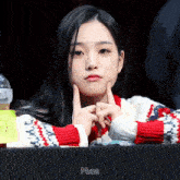 a woman sitting at a table with her hands on her chin and the word maze on the bottom right