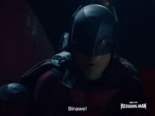 a man in a batman costume with the words binawe on the bottom