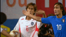 two soccer players one of whom has the number 10 on their jersey