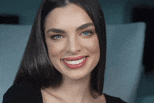 a close up of a woman 's face smiling