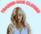 a woman with blonde hair stands in front of a sign that says " trader has closed "