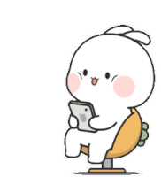 a rabbit is sitting in a chair holding a cell phone .