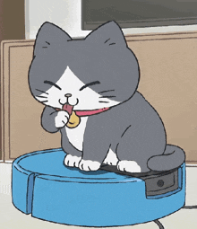 a cartoon cat is sitting on top of a blue robotic vacuum cleaner