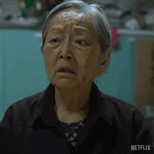 a close up of a woman 's face with a netflix logo on the bottom right