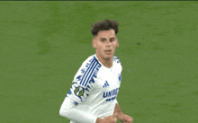 a soccer player wearing a white jersey that says unibet on it