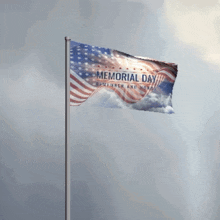 a flag that says memorial day is flying in the wind