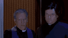 a man in a suit and tie is standing next to another man