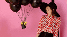 a woman wearing a hat and a shirt with kisses on it