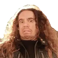 a man with long curly hair and a nose ring making a funny face