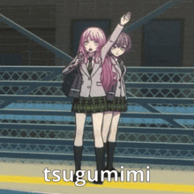 two anime girls are standing next to each other and the word tsugumimi is on the ground in front of them