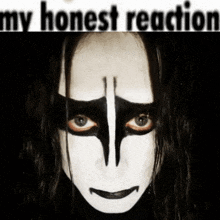 a woman with black and white paint on her face with the words " my honest reaction " underneath her