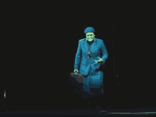 a man in a suit and tie is holding a briefcase on a stage .