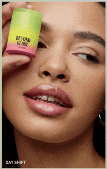 a close up of a woman holding a beyond glow product