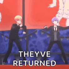 a couple of anime characters are dancing on a stage .