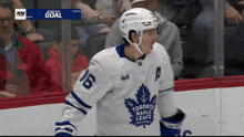 a toronto maple leafs hockey player is standing on the ice