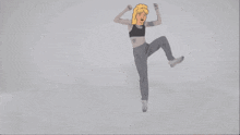 a cartoon drawing of a woman in a black top and grey pants dancing