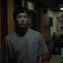 two men are looking at each other and one has glasses