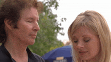 a man and a woman are looking at each other with their eyes closed