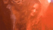 a blurry picture of a woman 's face in a red light