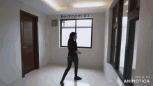 a woman is standing in a room with the words bedroom # 1 on the ceiling