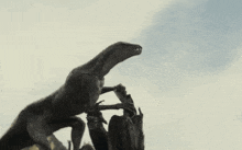 a statue of a dinosaur is standing on a tree branch