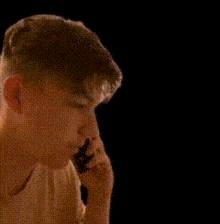 a young boy is making a shhh sign with his finger to his mouth .