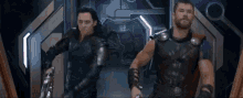 loki and thor are walking down a hallway in a movie .