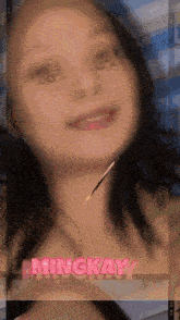 a close up of a woman 's face with the name mingkay on the bottom right
