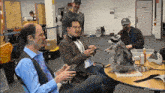 a raccoon is sitting at a table with a group of people