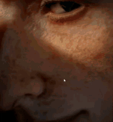 a close up of a person 's eye with a small white arrow pointing to the eye