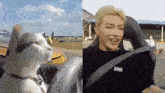 a cat sitting in a car next to a man sitting in a car