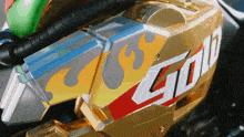 a close up of a gold colored object with the word gold on it
