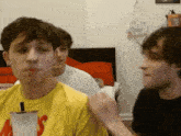 a man in a yellow t-shirt with the word ' s ' on it