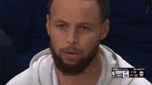 a man with a beard is watching a basketball game on tnt