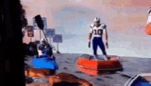 a football player with the number 10 on his jersey stands on a raft in the water