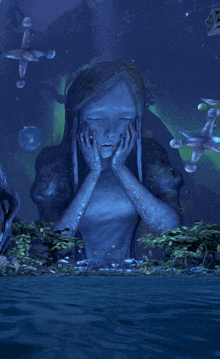 a statue of a woman with her eyes closed is surrounded by water