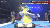 a woman in a yellow dress stands on a wrestling ring in front of a sign that says historic x-ever 8