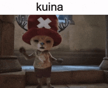 a stuffed animal wearing a red hat with an x on it is standing on a set of stairs