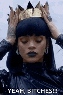 a woman is wearing a crown on her head and says yeah , bitches !