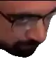 a man with a beard and glasses is looking down .