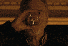 an older man with a beard looks at the camera