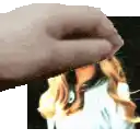 a close up of a hand holding a picture of a woman 's face
