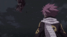 a man with pink hair is standing in front of a large dragon
