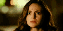 a close up of a woman 's face with a surprised expression .