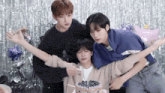 a group of young men are standing around a cake with blueberries on it