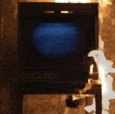 a television is on fire with a blue screen and smoke coming out