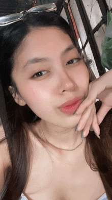 a woman taking a selfie with her hand on her face