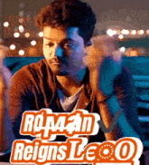 a man sitting in front of a sign that says ' reigns leo '