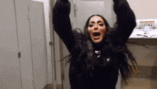 a woman in a black sweater is screaming in a bathroom